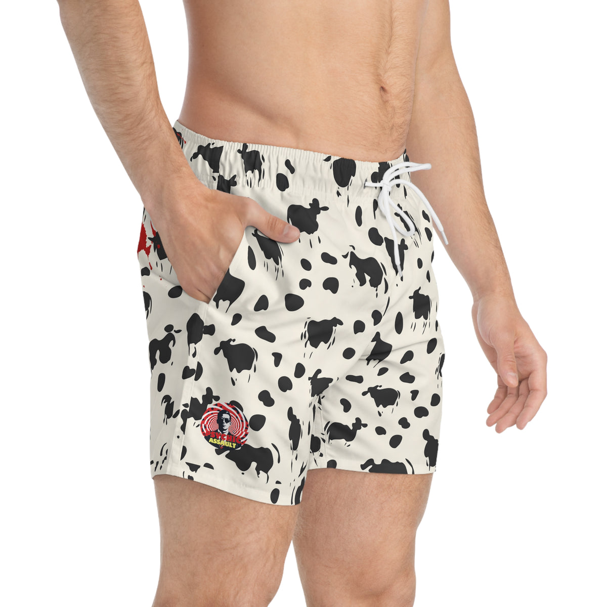 Off-white swim trunks with a black cow print and a red Psychic Assault graphic on the leg.