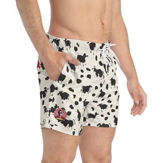 Off-white swim trunks with a black cow print and a red Psychic Assault graphic on the leg.