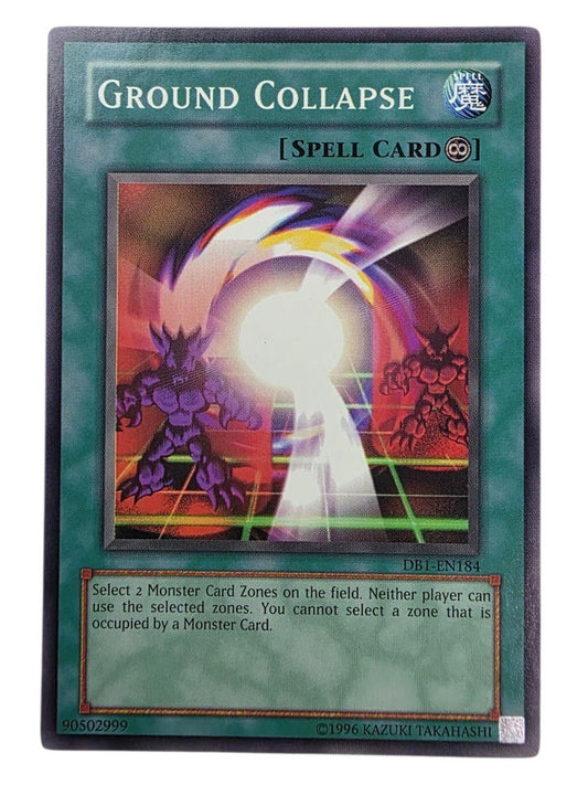 Ground Collapse Yu-Gi-Oh! Spell card with two horned monsters and a glowing light effect.