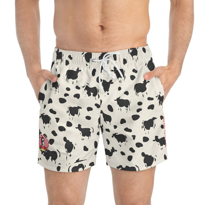 Off-white swim trunks with a black cow and spot print, featuring a white drawstring waist.
