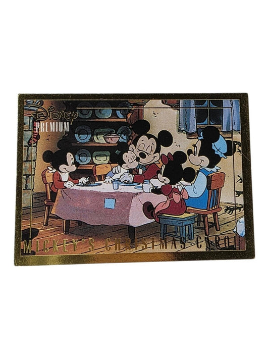 1995 Disney Trading Card with gold border, showing Mickey's Christmas Carol characters eating at a pink-clothed table.