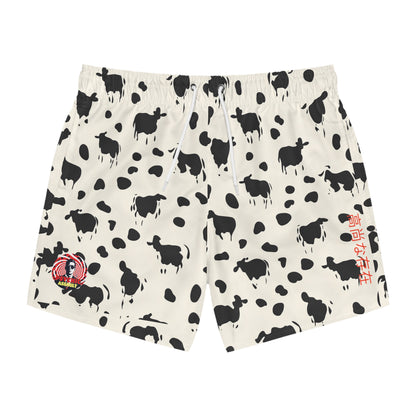 Off-white swim trunks with an all-over black cow silhouette and abstract spot pattern, plus drawstrings.