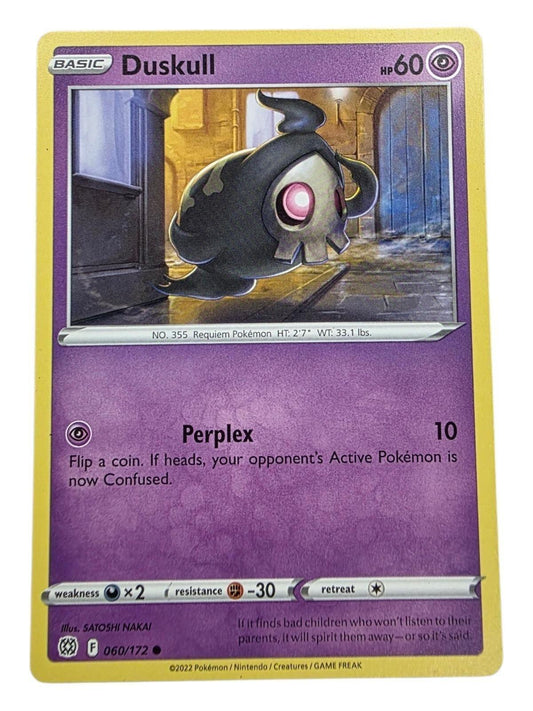 Duskull 060/172 Pokémon trading card from Brilliant Stars, showing the ghost-type Pokémon in a dark alley.