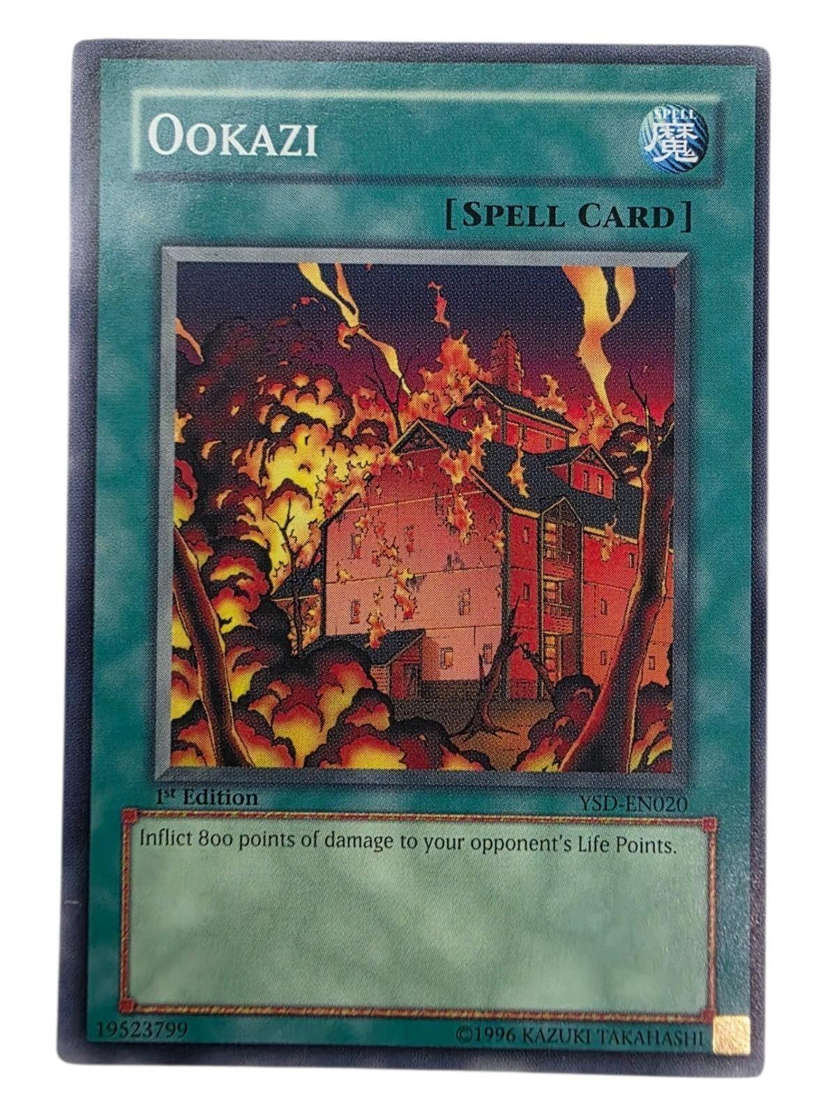 Ookazi 1st Edition Common Spell Card featuring art of a burning building.