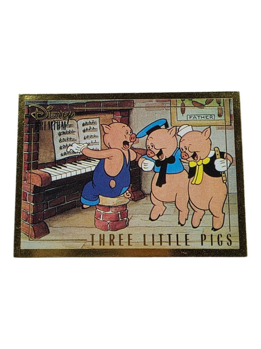 Disney Three Little Pigs decorative plaque with gold trim showing three pigs by a piano, with text "Three Little Pigs".