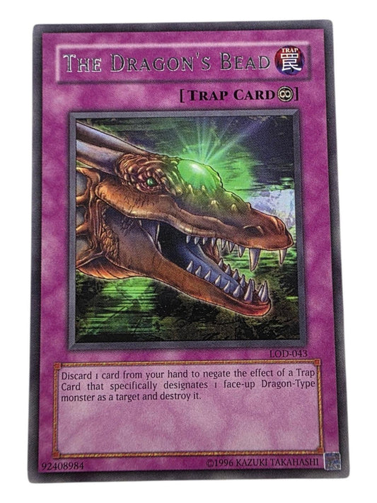 The Dragon's Bead Yu-Gi-Oh! trap card, LOD-EN04, featuring a dragon head with a glowing green bead.