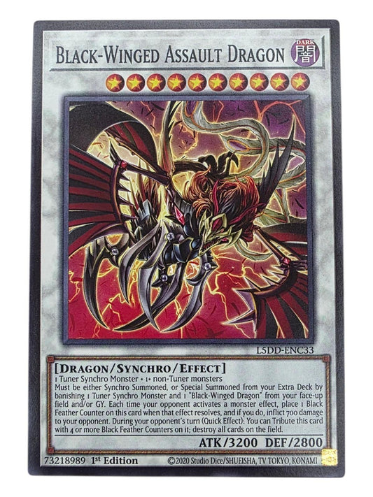 Black-Winged Assault Dragon Yu-Gi-Oh! card featuring a dark, spiked dragon against a red background.