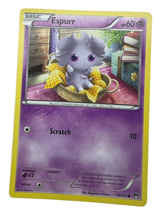 Espurr 58/122 Pokémon card featuring the purple psychic-type creature sitting in a small basket with a yellow blanket.