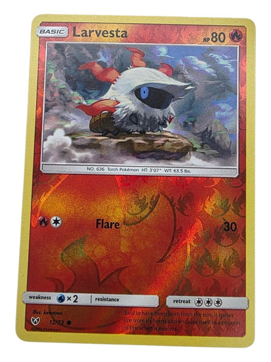 Larvesta 12/73 Shining Legends Pokémon card with foil fire pattern and white-haired character.