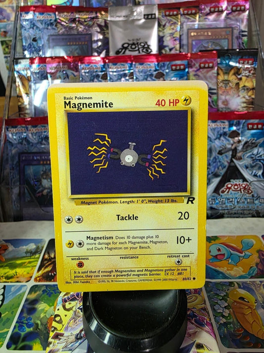 Magnemite 60/82 Team Rocket common Pokémon card with yellow border and purple artwork background.