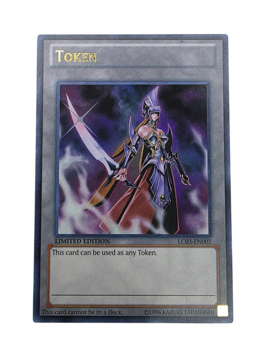 Token: Emissary of Darkness trading card from Yu-Gi-Oh! featuring a warrior in purple armor holding a sword.