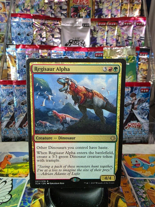 Magic: The Gathering Regisaur Alpha card from Ixalan, showing art of dinosaurs in a landscape.
