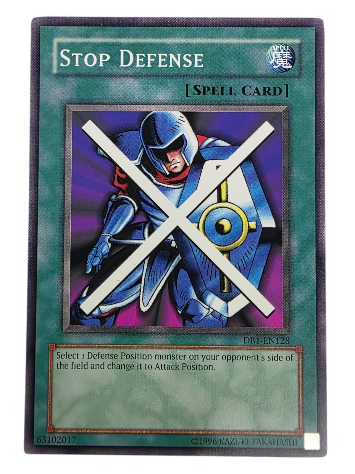 Stop Defense Yu-Gi-Oh! Spell card featuring an armored warrior with a blue shield and a white 'X' across the artwork.