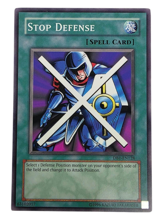 Stop Defense Yu-Gi-Oh! Spell card featuring an armored warrior with a blue shield and a white 'X' across the artwork.