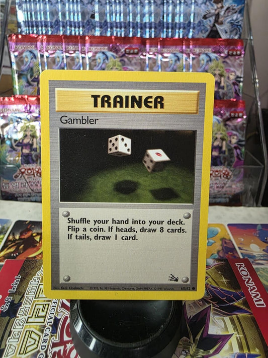 Yellow-bordered Pokémon Trainer Gambler card with an illustration of two dice falling against a dark green backdrop.