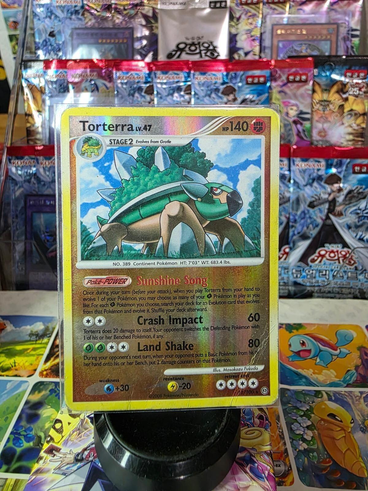 Torterra reverse holo Pokemon card with shiny foil finish against a display background.