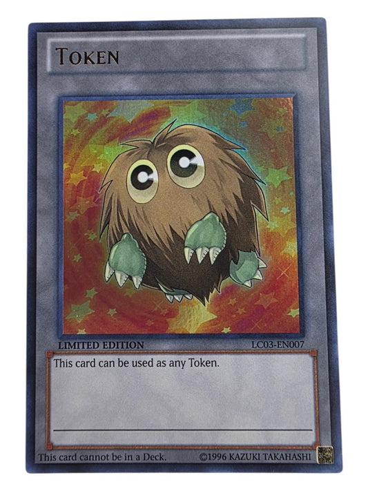 Yu-Gi-Oh! Token card featuring a fluffy brown creature with green paws against a star-patterned foil background.