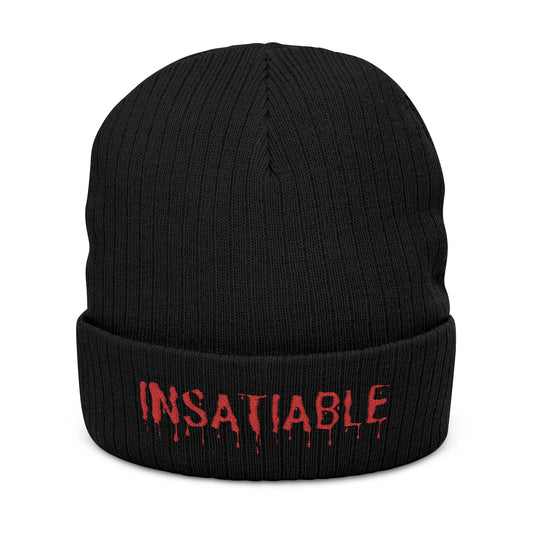 Black ribbed knit beanie with red embroidered "INSATIABLE" text featuring a dripping design.