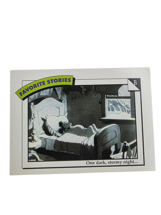 Black-and-white Disney trading card with a "FAVORITE STORIES" yellow-and-blue banner, showing a character in bed.