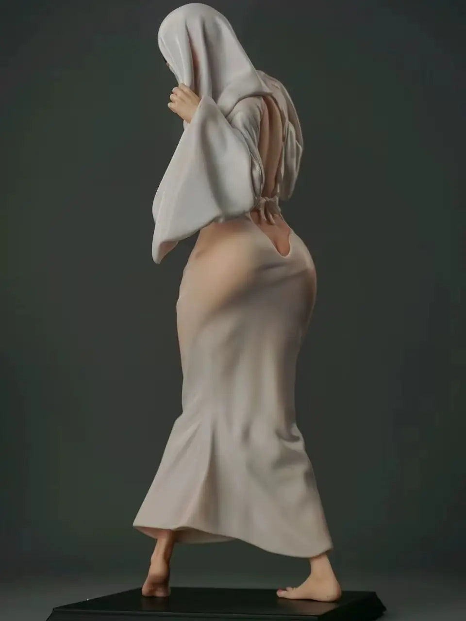 Ghost Girl figurine model in a long white dress, draped headpiece, and bare feet on a dark base.
