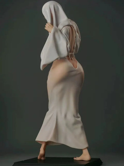 A white-robed figurine with an open back and a hood covering its face, standing on a dark rectangular base.