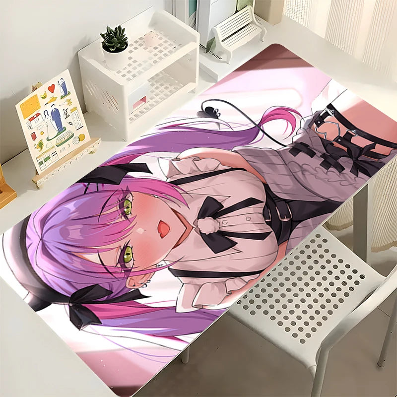Tokoyami Towa desk mat featuring a pink-haired anime girl in a white shirt and black bows on a desk.