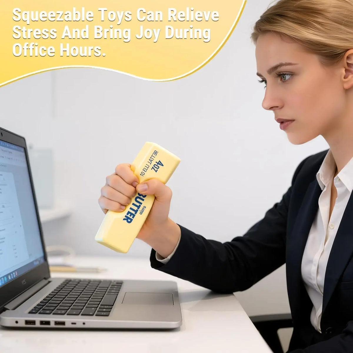 A woman in an office squeezes a yellow butter-shaped stress toy in her hand.