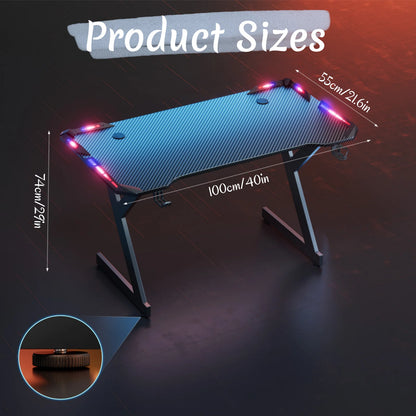 Black Y-shaped gaming desk with blue carbon-fiber surface, red-and-blue LED lights, and size dimension lines.