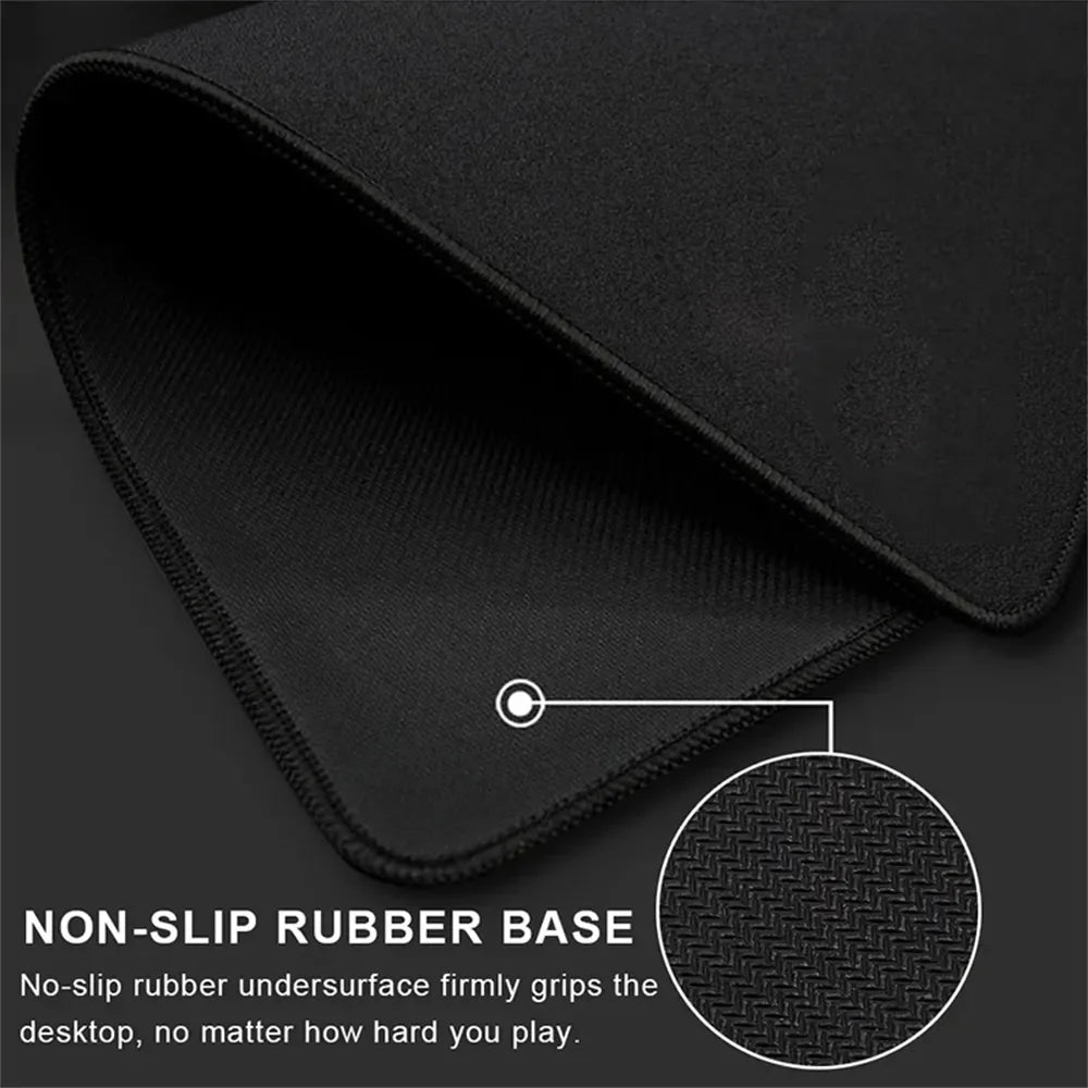 Black gaming mouse pad with stitched edges and a textured non-slip rubber base.