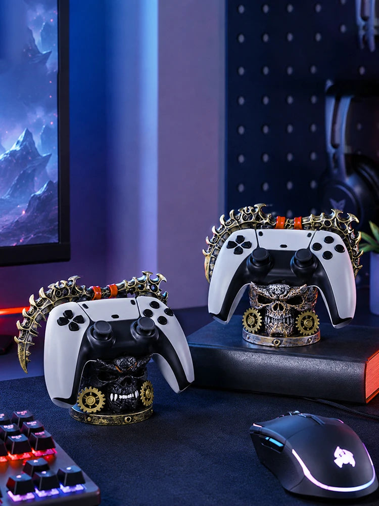 Two steampunk skull controller stands hold white and black gamepads on a dark desk.