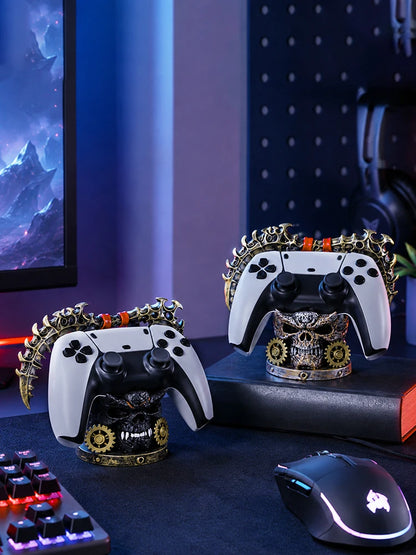 Two steampunk skull controller stands hold white and black gamepads on a dark desk.