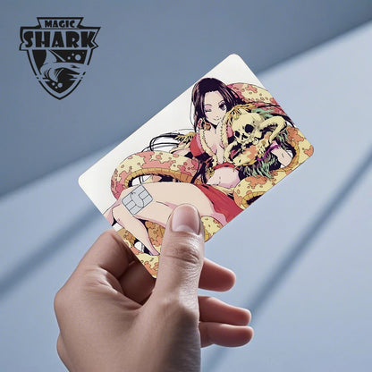 Anime debit card skin featuring an anime woman with long black hair, a yellow snake, and a skull in red and yellow.