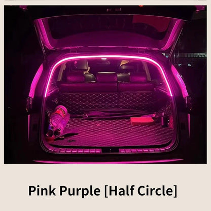 An open car trunk illuminated by a glowing pink LED strip lining the frame, highlighting the interior cargo area.