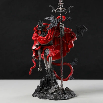 PVC figurine in red and black holding a staff, with a red snake and black bat wings.