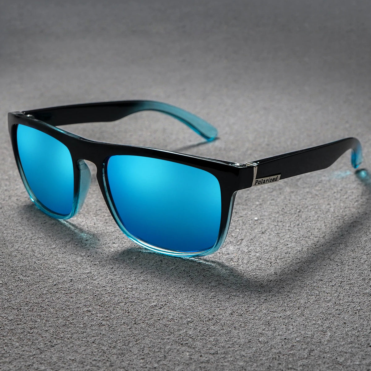 Polarized square sunglasses with vibrant blue lenses and black frames that fade to translucent blue tips.