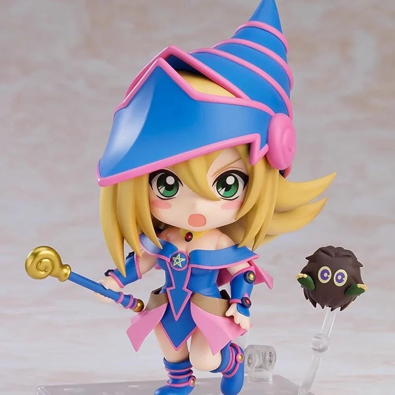 Chibi Dark Magician Girl figurine in blue and pink outfit, holding a golden staff, with a Kuriboh nearby.