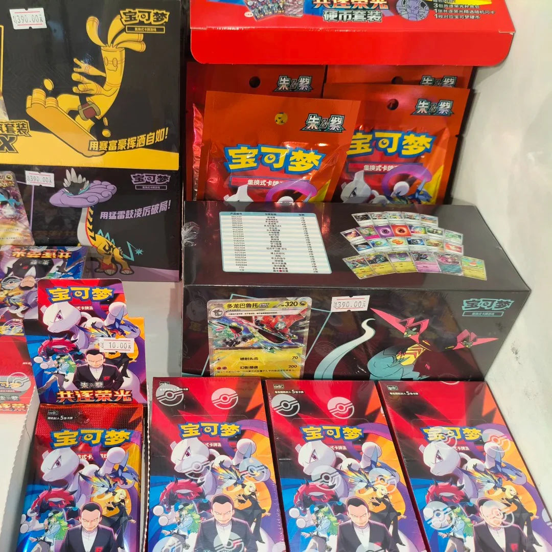 Simplified Chinese Pokémon trading card boxes and booster packs featuring colorful character art and red, yellow, and black designs.