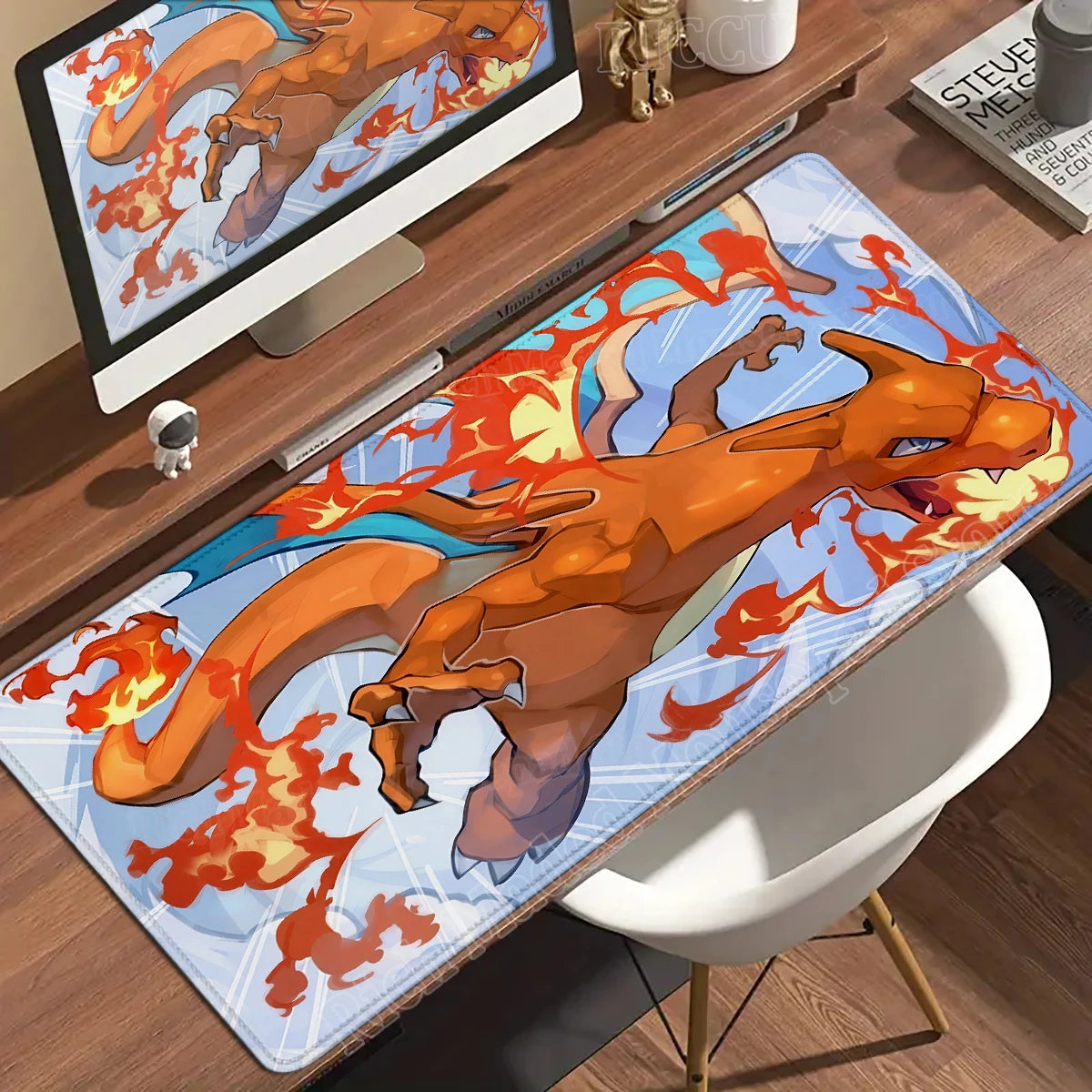 Large anime Charizard desk mat featuring the orange dragon breathing fire against a light blue background.