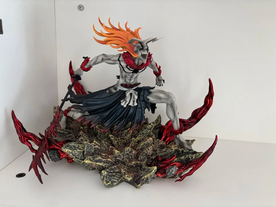 Bleach Ichigo figurine in hollow bull head form, gray skin, orange hair, dark clothing, rocky base with red energy.