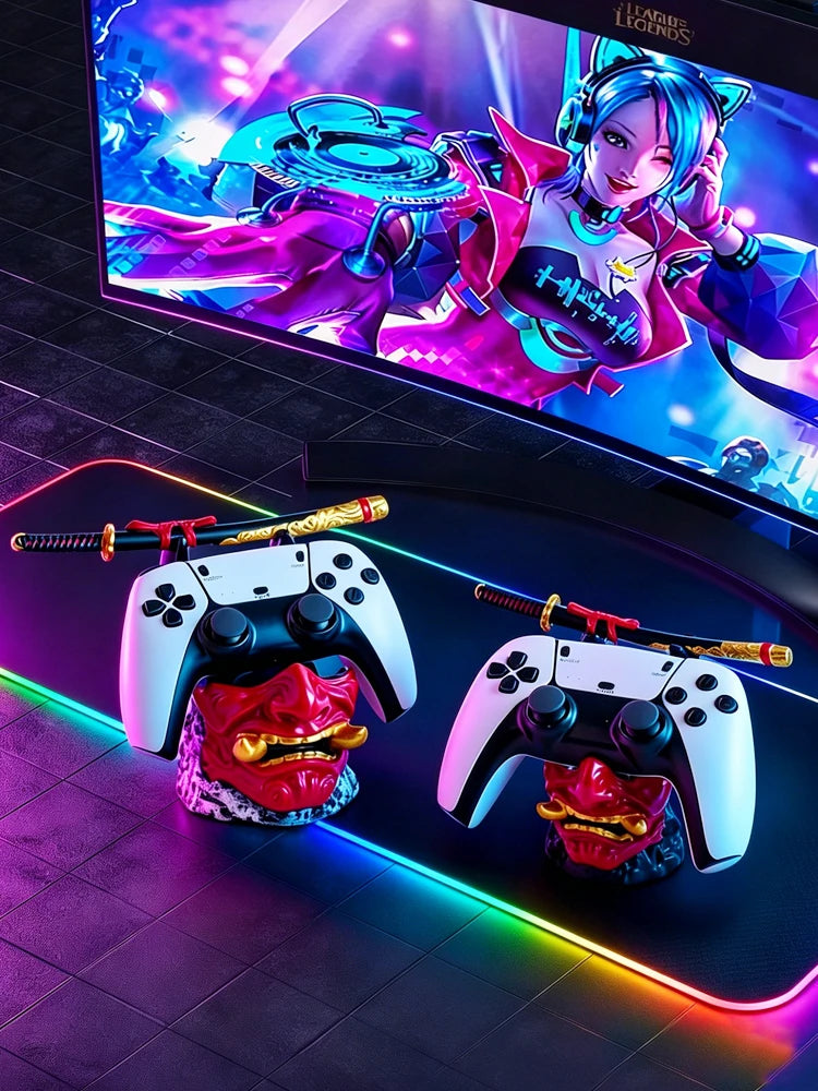 Two red and gold oni mask controller holders, each supporting a white controller and miniature samurai sword.