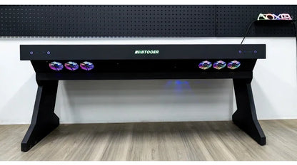 A black desk with an integrated computer chassis, featuring glowing RGB fans and the "BTOOER" logo.