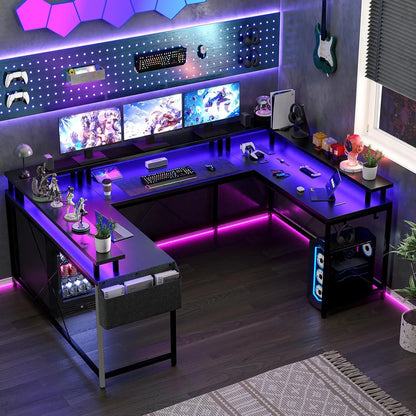 A large black U-shaped gaming desk lit by purple LED strips, featuring three monitors, a PC tower, and wall pegboards.