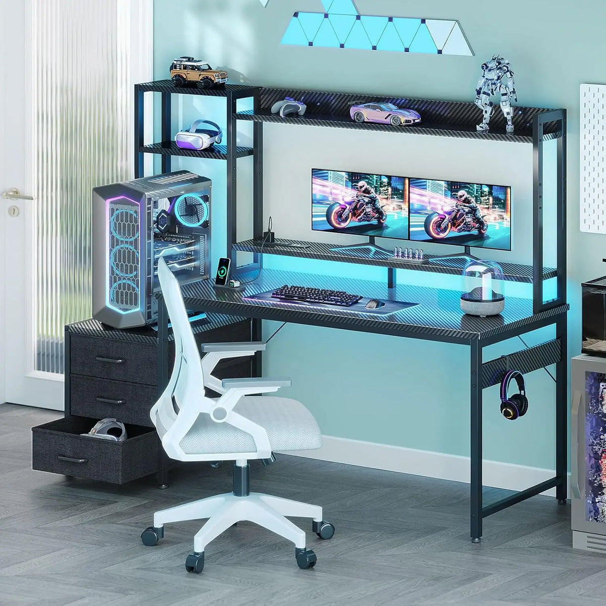 Black gaming desk with hutch, shelves, three fabric drawers, LED lighting, dual monitors, and a white office chair.