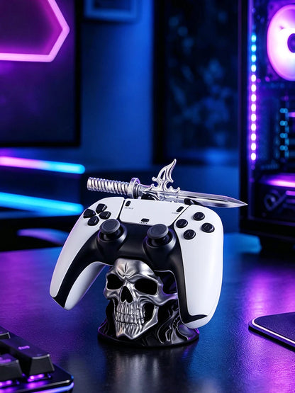 Silver skull game controller stand holding a white and black controller, topped with a silver sword.