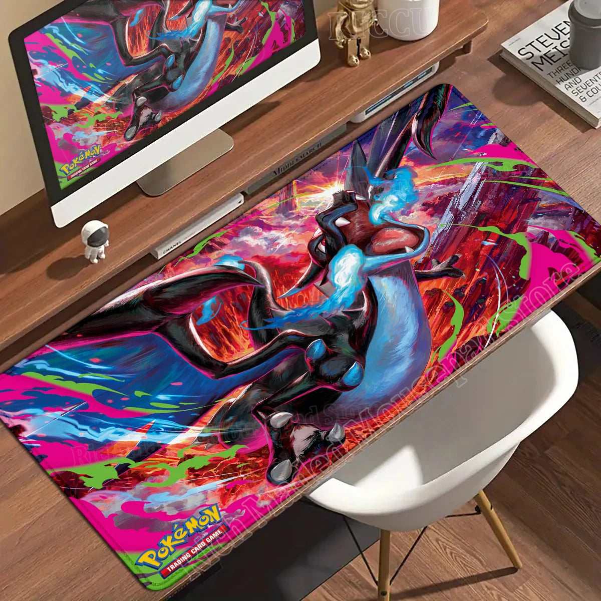 A large desk mat featuring a black and blue Charizard in flight against a fiery red, pink, and blue background.