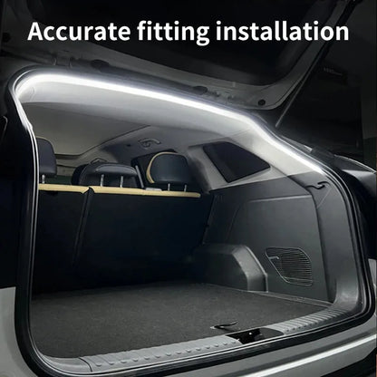A bright white LED light strip is installed along the inner upper edge of an open car trunk.