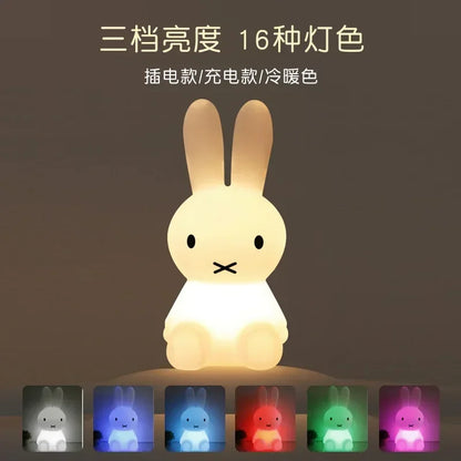 A glowing white Miffy rabbit night light glows with a warm light, with small color option tiles below.