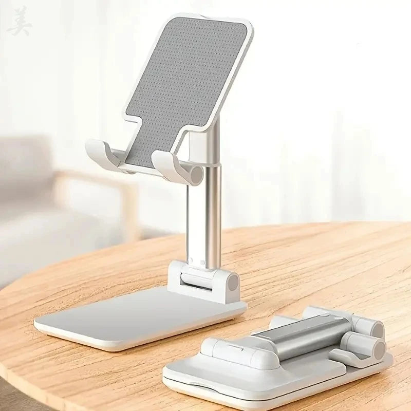 White and silver adjustable desk stand with a grey pad, shown upright and folded on a wooden table.