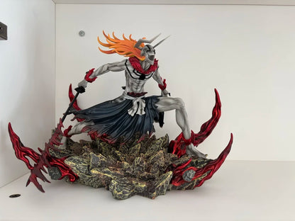 Grey horned Ichigo figure with orange hair, dark clothing, and red sword on a rocky base.