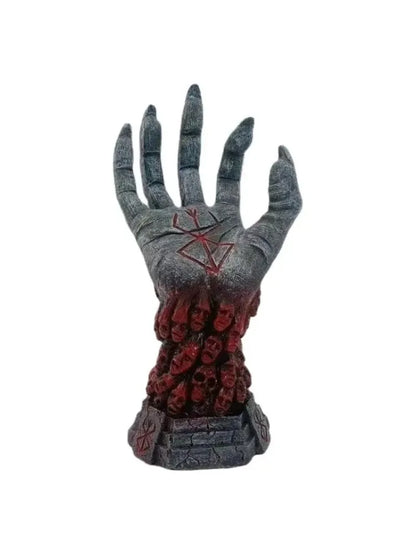 Grey sculpted hand with a red palm symbol, emerging from a red mass of faces atop a grey tiered base.